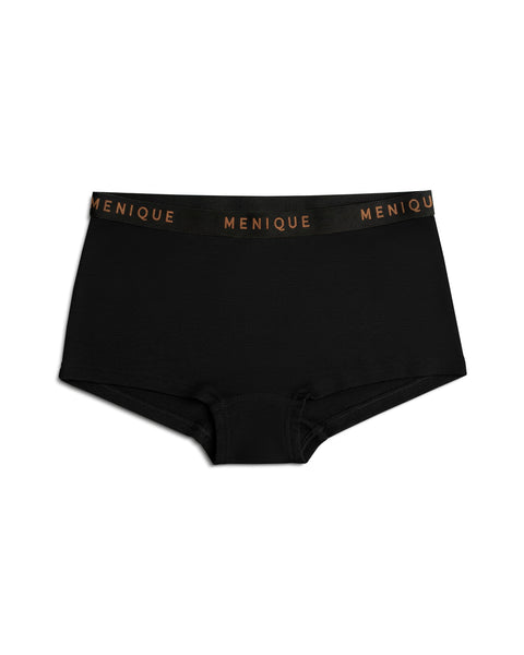 A product shot of black women's boxer briefs laid flat against a plain white background. The underwear features a black elastic waistband with the brand name "MENIQUE" woven repeatedly in bronze lettering.