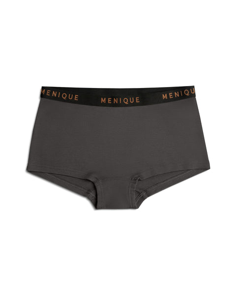 A product shot of charcoal grey women's boxer briefs laid flat against a plain white background. The underwear features a black elastic waistband with the brand name "MENIQUE" woven repeatedly in bronze lettering.