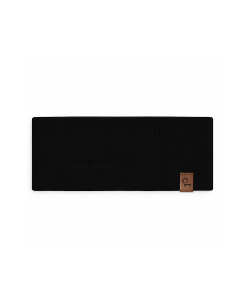 Product flat lay displaying a solid black rectangular knit fabric headband with a small brown leather brand tag, laid flat against a white background.