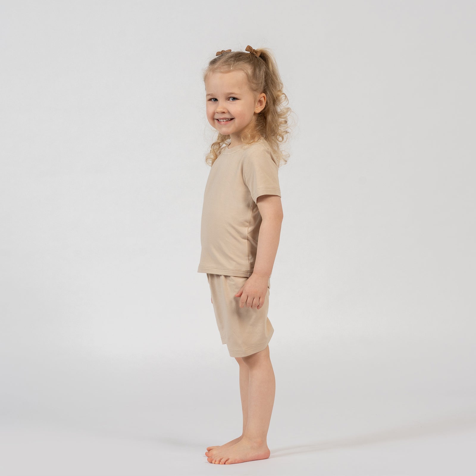 Kids pink bamboo t-shirt and shorts set, lightweight and gentle clothing for daily wear.