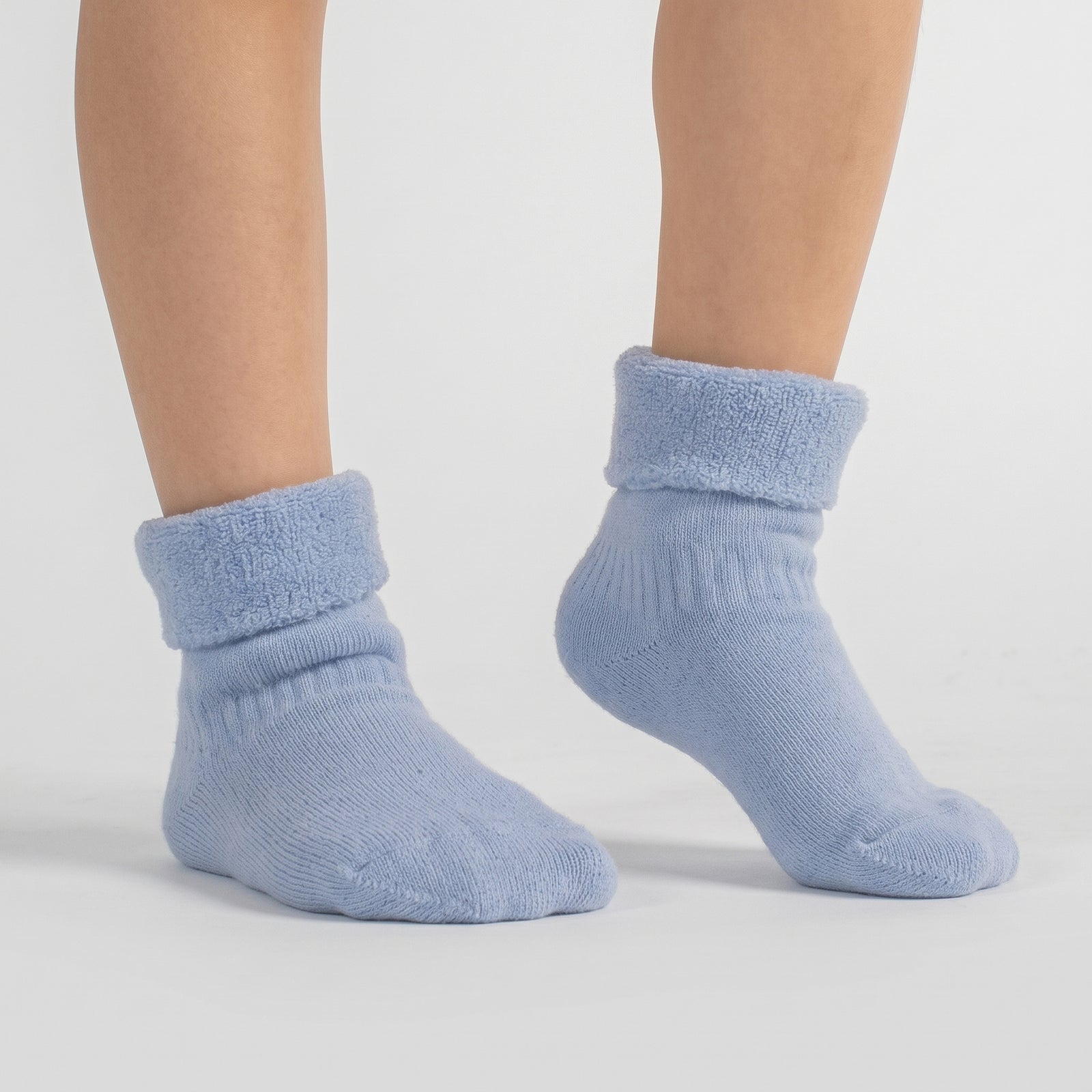 A 3-pack of kids’ light blue sherpa-lined merino wool socks with Menique branding.