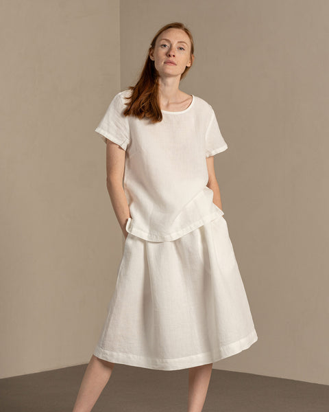 Woman wearing Linen short sleeve top Emma in Pure WHite color matched with Linen skirt Sophia