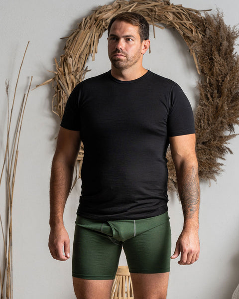 A man wearing the menique men&#39;s boxer underwear in color dark green.