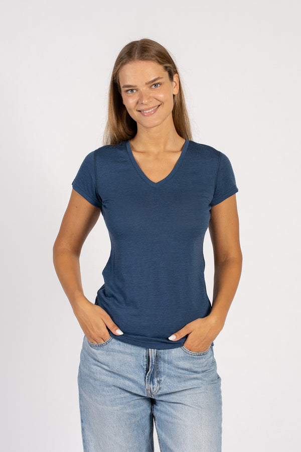 Woman smiling in a denim blue Merino wool V-neck short sleeve T-shirt.