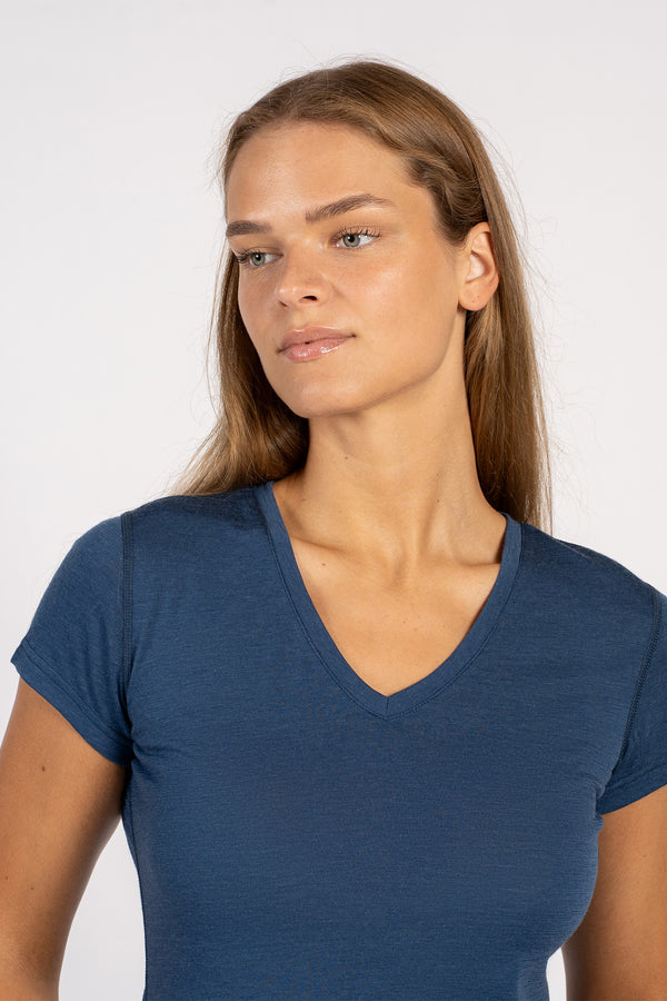Close-up of a woman wearing a denim Merino wool V-neck short sleeve T-shirt.