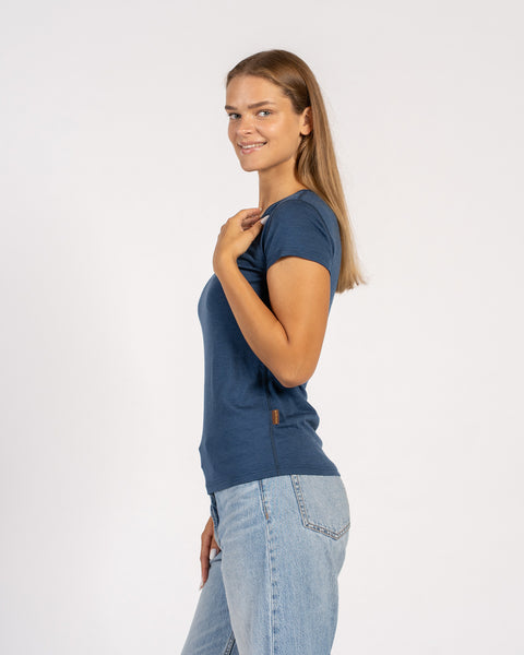 Side view of a denim blue women’s Merino wool V-neck short sleeve T-shirt.