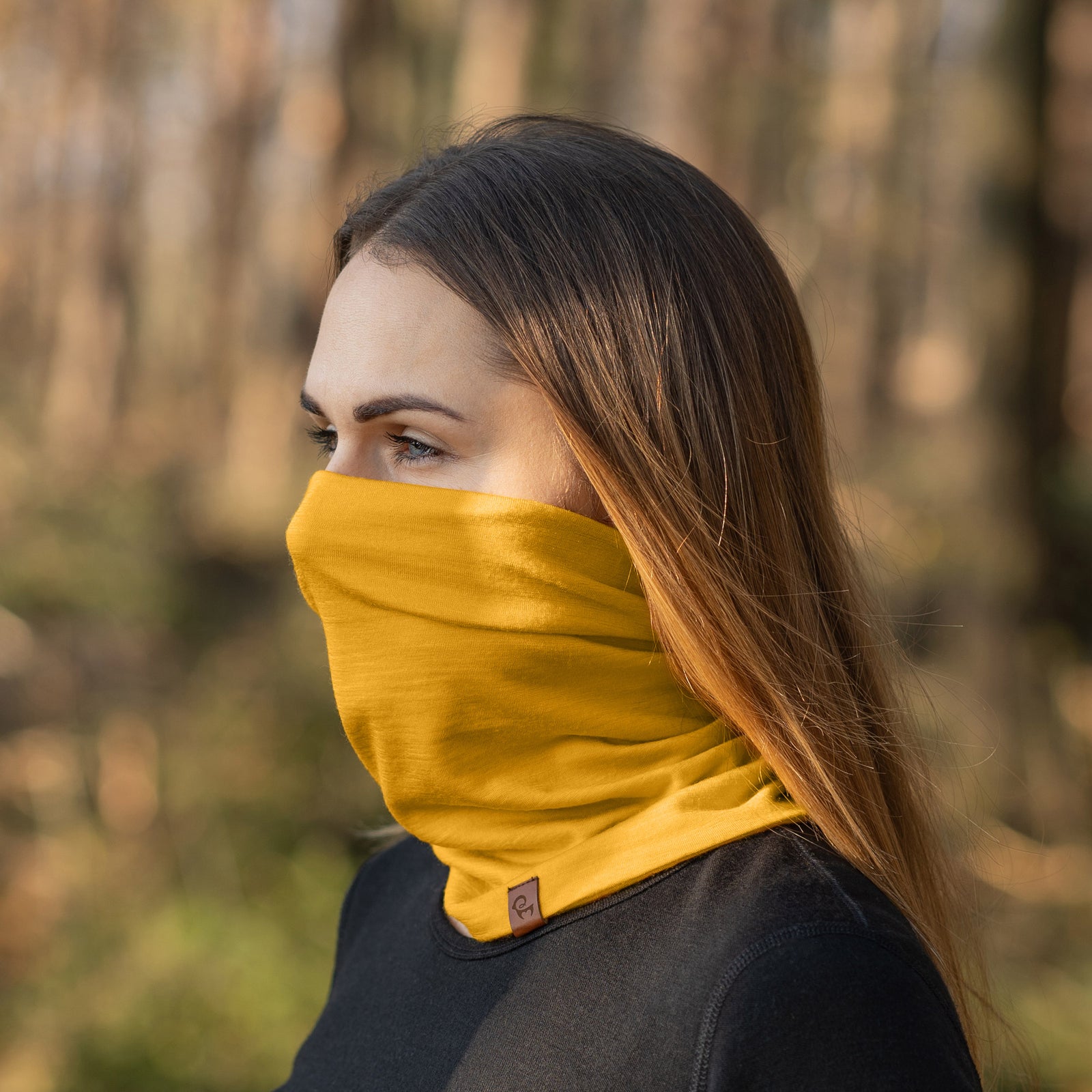 A detailed close-up product shot of the Menique Unisex Spicy Yellow Neck Gaiter, highlighting its vibrant yellow color and soft, breathable fabric. The gaiter's seamless design and stretchy material are emphasized, showing how it can comfortably fit various head and neck sizes. 