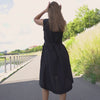 MENIQUE Linen sleeveless asymmetrical dress in pure black color with added waist belt.