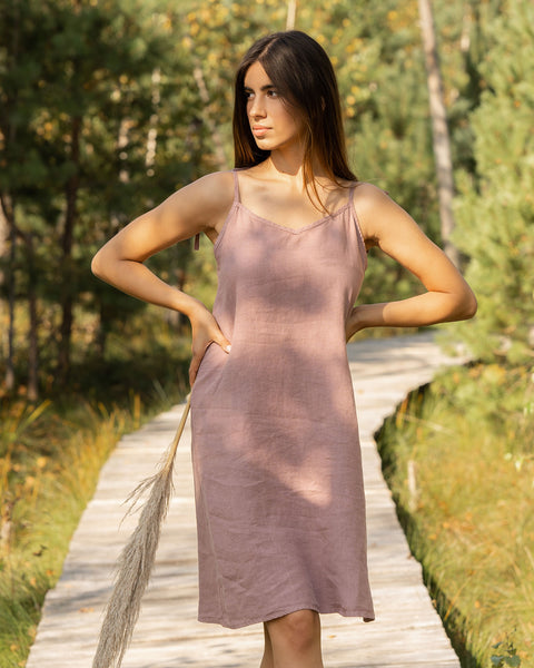 Woman wearing slip linen dress in faded rose color