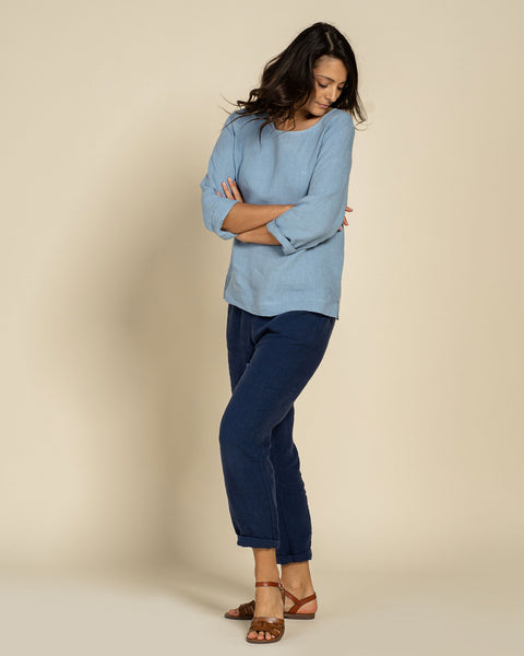 Woman wearing linen blouse in cloudy blue color front 